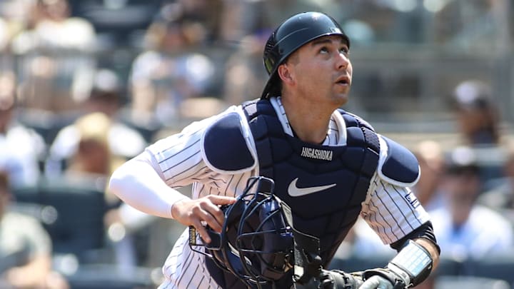 New York Yankees catcher Kyle Higashioka (66) chases after a ball.