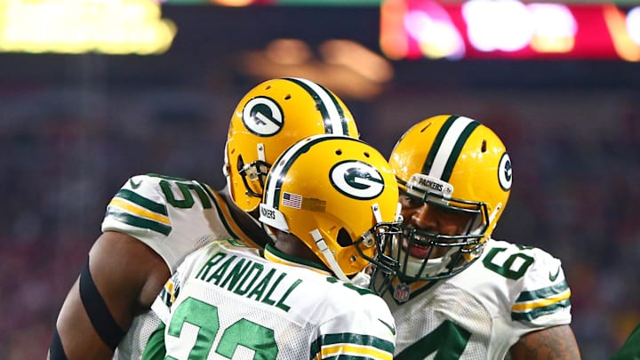 Jan 16, 2016; Glendale, AZ, USA; Green Bay Packers cornerback Damarious Randall (23) celebrates an interception with defensive tackle Mike Pennel (64) against the Arizona Cardinals during the NFC Divisional round playoff game at University of Phoenix Stadium. Mandatory Credit: Mark J. Rebilas-Imagn Images