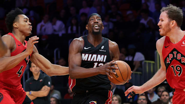 Dec 15, 2025; Miami, Florida, USA; Miami Heat center Bam Adebayo (13) drives to the basket against Toronto Raptors forward Scottie Barnes (4) and center Jakob Poeltl (19) during the fourth quarter at Kaseya Center. Mandatory Credit: Sam Navarro-Imagn Images Dec 15, 2025; Miami, Florida, USA; Miami Heat center Bam Adebayo (13) drives to the basket against Toronto Raptors forward Scottie Barnes (4) and center Jakob Poeltl (19) during the fourth quarter at Kaseya Center. Mandatory Credit: Sam Navarro-Imagn Images