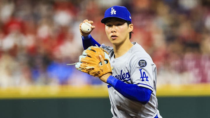 Jul 28, 2025; Cincinnati, Ohio, USA; Los Angeles Dodgers second baseman Hyeseong Kim (6) throws to first to get Cincinnati Reds outfielder TJ Friedl (not pictured) out in the eighth inning at Great American Ball Park. Mandatory Credit: Katie Stratman-Imagn Images