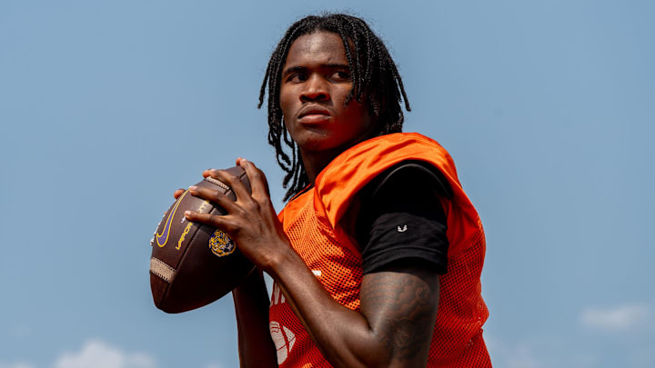 Quarterback Bryce Underwood prepares to throw a pass during a team practice at the Belleville High School football field in Belleville on Wednesday, Aug. 14, 2024.