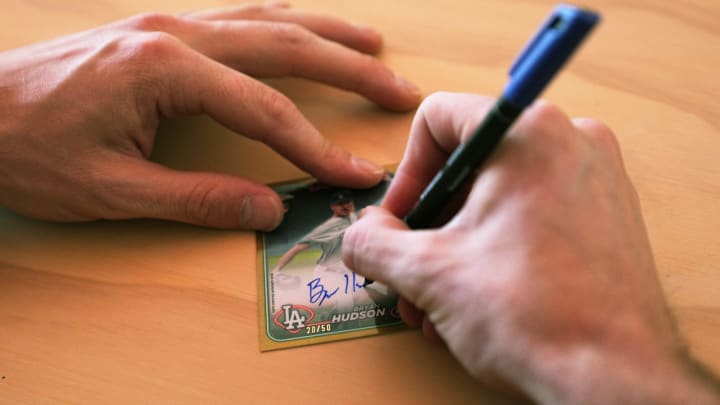 Pitcher Bryan Hudson, acquired last month by the Milwaukee Brewers from the Los Angeles Dodger, signs a card at Topps Spot card signing house in Scottsdale on Feb. 19, 2024. Pitcher Bryan Hudson, acquired last month by the Milwaukee Brewers from the Los Angeles Dodger, signs a card at Topps Spot card signing house in Scottsdale on Feb. 19, 2024.