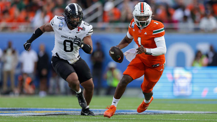 Dec 28, 2024; Orlando, FL, USA; Miami Hurricanes quarterback Cam Ward (1) runs with the ball against the Iowa State Cyclones in the second quarter during the Pop Tarts bowl at Camping World Stadium. Mandatory Credit: Nathan Ray Seebeck-Imagn Images
