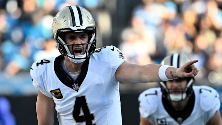 Nov 3, 2024; Charlotte, North Carolina, USA; New Orleans Saints quarterback Derek Carr (4) at the line of scrimmage in the fourth qarter at Bank of America Stadium. Mandatory Credit: Bob Donnan-Imagn Images