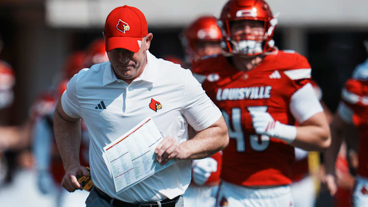 Louisville Cardinals head football coach Jeff Brohm runs onto the field with his team as they take on visiting Bowling Green in Louisville, Kentucky. Sept. 20, 2025