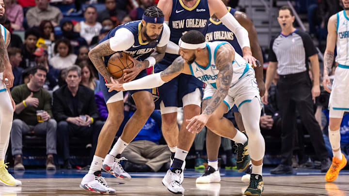 Jan 17, 2024; New Orleans, Louisiana, USA;  Charlotte Hornets forward Miles Bridges (0) attempts to steal the ball from New Orleans Pelicans forward Brandon Ingram (14) during the second half at Smoothie King Center. Mandatory Credit: