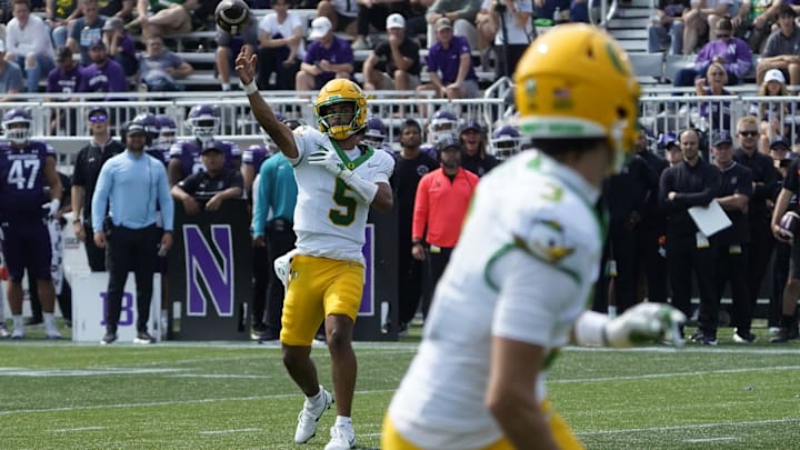 Sep 13, 2025; Evanston, Illinois, USA; Oregon Ducks quarterback Dante Moore (5) throws the ball against the Northwestern Wildcats during the second half at Northwestern Medicine Field at Martin Stadium. Mandatory Credit: David Banks-Imagn Images