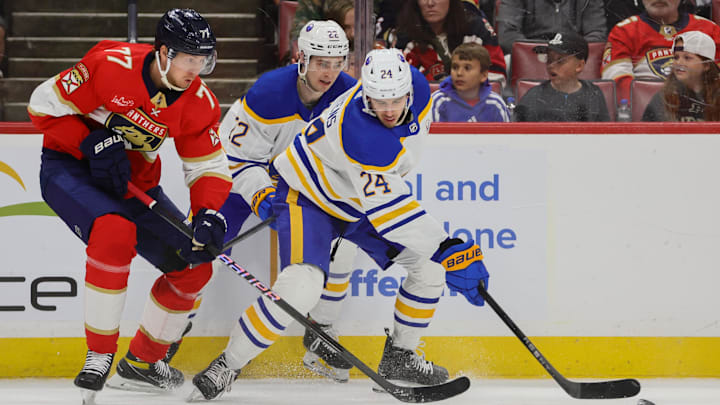 Apr 13, 2024; Sunrise, Florida, USA; Buffalo Sabres center Dylan Cozens (24) protects the puck from