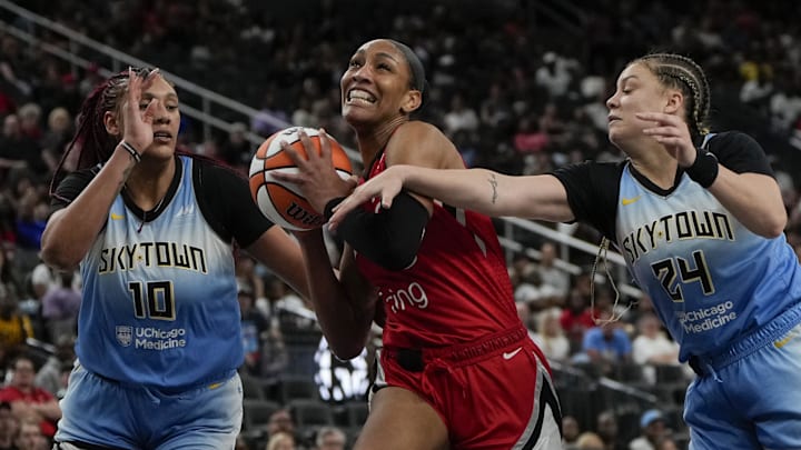 Sep 7, 2025; Las Vegas, Nevada, USA; Las Vegas Aces center A'ja Wilson (22) drives the ball between Chicago Sky center Kamilla Cardoso (10) and guard Rachel Banham (24) during the second half of a WNBA basketball game at T-Mobile Arena. Mandatory Credit: Lucas Peltier-Imagn Images Sep 7, 2025; Las Vegas, Nevada, USA; Las Vegas Aces center A'ja Wilson (22) drives the ball between Chicago Sky center Kamilla Cardoso (10) and guard Rachel Banham (24) during the second half of a WNBA basketball game at T-Mobile Arena. Mandatory Credit: Lucas Peltier-Imagn Images