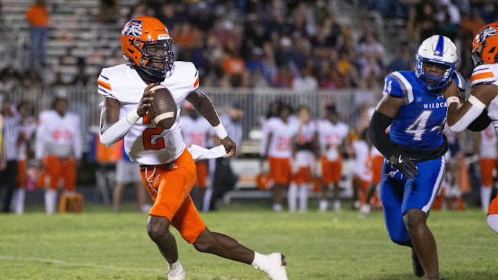 Quarterback Nino Freeman (2) fades back while looking for an open receiver during the Escambia vs Washington football game at Booker T. Washington High School in Pensacola on Friday, Sept. 27, 2024.