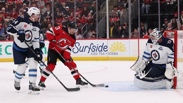 New Jersey Devils left wing Jesper Bratt (63) scores a goal on Winnipeg Jets goaltender Connor Hellebuyck (37) during the second period at Prudential Center. Mandatory Credit: Ed Mulholland-Imagn Images