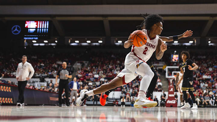 Jan 21, 2025; Tuscaloosa, Alabama, USA; Alabama Crimson Tide guard Aden Holloway (2) drives the ball against Vanderbilt Commodores guard Jason Edwards (1) during the first half at Coleman Coliseum. Mandatory Credit: Will McLelland-Imagn Images Jan 21, 2025; Tuscaloosa, Alabama, USA; Alabama Crimson Tide guard Aden Holloway (2) drives the ball against Vanderbilt Commodores guard Jason Edwards (1) during the first half at Coleman Coliseum. Mandatory Credit: Will McLelland-Imagn Images