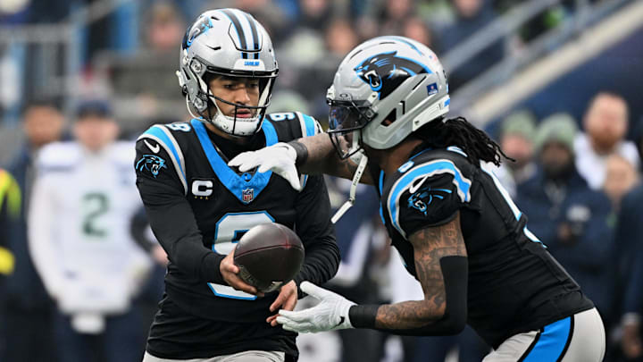 Dec 28, 2025; Charlotte, North Carolina, USA; Carolina Panthers quarterback Bryce Young (9) hands the ball to running back Rico Dowdle (5) against the Seattle Seahawks during the first quarter at Bank of America Stadium. Mandatory Credit: Bob Donnan-Imagn Images Dec 28, 2025; Charlotte, North Carolina, USA; Carolina Panthers quarterback Bryce Young (9) hands the ball to running back Rico Dowdle (5) against the Seattle Seahawks during the first quarter at Bank of America Stadium. Mandatory Credit: Bob Donnan-Imagn Images