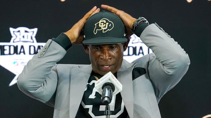 Jul 9, 2025; Frisco, TX, USA; Colorado head coach Deion Sanders fixes his cap prior to speaking with the media during 2025 Big 12 Football Media Days at The Star. Mandatory Credit: Raymond Carlin III-Imagn Images