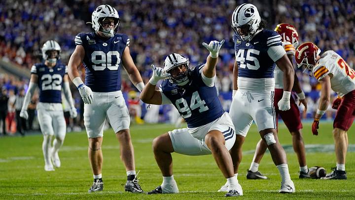 Oct 9, 2026; Provo, Utah, USA;  BYU Cougars defensive tackle Anisi Purcell (94) celebrates a second half sack with  defensive end Hunter Clegg (90) and defensive tackle Viliami Po'uha (45) during the second half against the Iowa State Cyclones at LaVell Edwards Stadium.  Mandatory Credit: Aaron Baker-Imagn Images