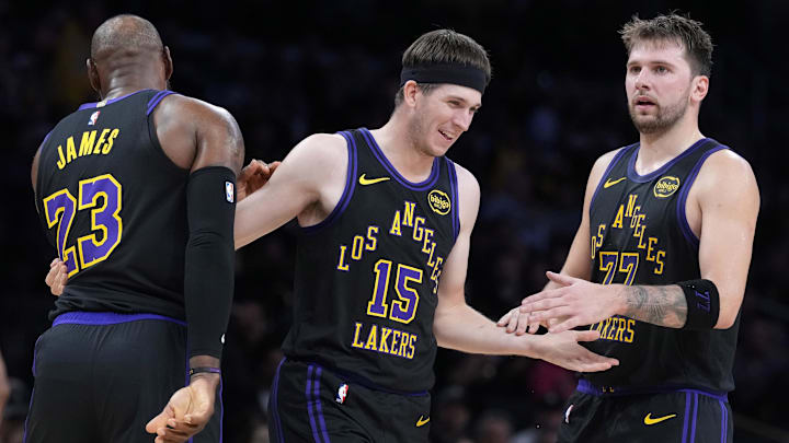 Los Angeles Lakers guard Austin Reaves is congratulated by forward LeBron James and guard Luka Doncic.