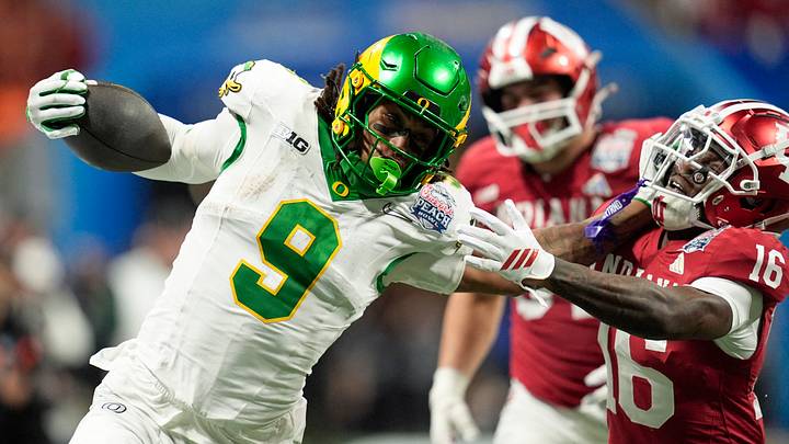 Jan 9, 2026; Atlanta, GA, USA; Oregon Ducks tight end Jamari Johnson (9) stiff arms Indiana Hoosiers defensive back Jah Jah Boyd (16) during the fourth quarter the 2025 Peach Bowl and semifinal game of the College Football Playoff at Mercedes-Benz Stadium. Mandatory Credit: Dale Zanine-Imagn Images
