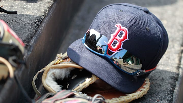 Mar 7, 2015; Sarasota, FL, USA; A general view of  Boston Red Sox hat and glove laying in the dugout at a spring training baseball game at Ed Smith Stadium. Mandatory Credit: Kim Klement-Imagn Images