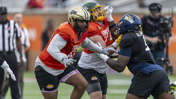 Jan 30, 2025; Mobile, AL, USA; National team offensive lineman Grey Zabel of North Dakota State (77) and National team defensive lineman Darius Alexander of Toledo (9) battle through drills during Senior Bowl practice for the National team at Hancock Whitney Stadium. Also pictured is National team offensive lineman Marcus Mbow of Purdue (63). 