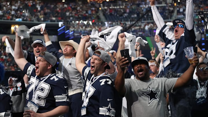 Dallas Cowboys fans cheer on their team from the floor of AT&T Stadium 