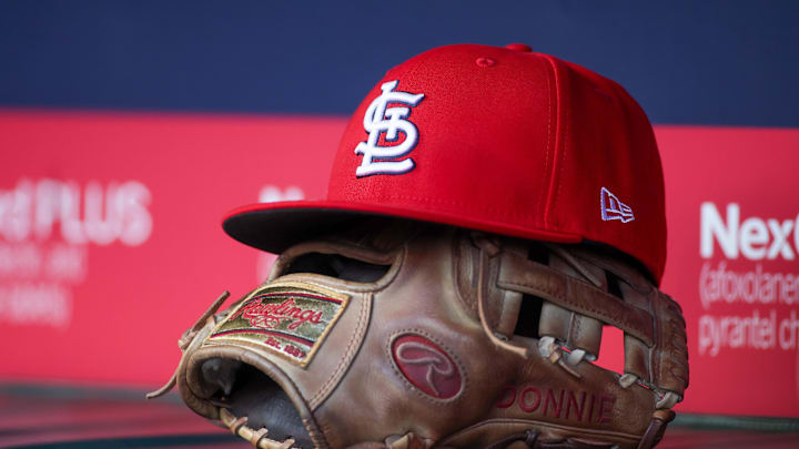 Apr 21, 2025; Atlanta, Georgia, USA; A St. Louis Cardinals hat and glove in the dugout against the Atlanta Braves in the first inning at Truist Park. Mandatory Credit: Brett Davis-Imagn Images
