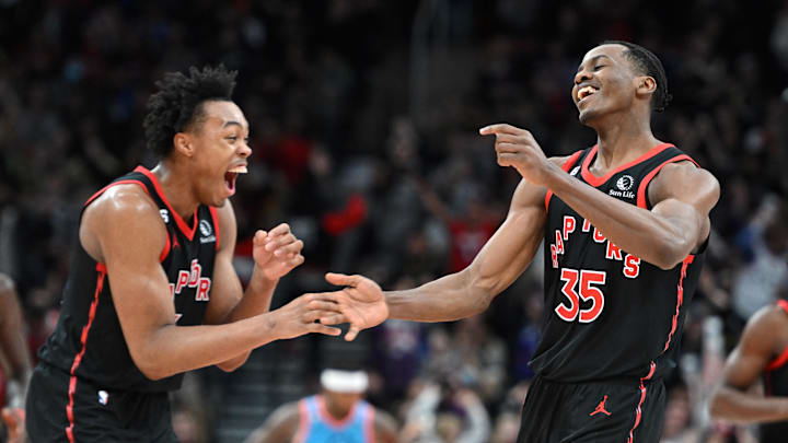 Dec 30, 2022; Toronto, Ontario, CAN;   Toronto Raptors center Christian Koloko (35) celebrates with forward Scottie Barnes (4) after making a three point basket against the Phoenix Suns in the second half at Scotiabank Arena. Mandatory Credit: Dan Hamilton-Imagn Images