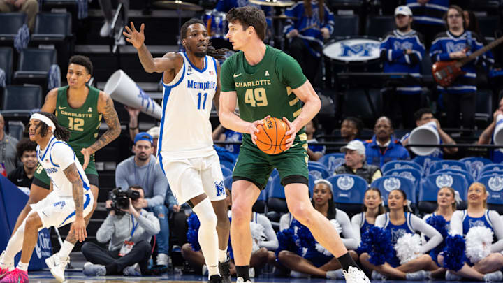 Feb 8, 2026; Memphis, Tennessee, USA; Charlotte 49ers center Anton Bonke (49) handles the ball against Memphis Tigers forward Aaron Bradshaw (11) during the first half at FedExForum. Mandatory Credit: Wesley Hale-Imagn Images