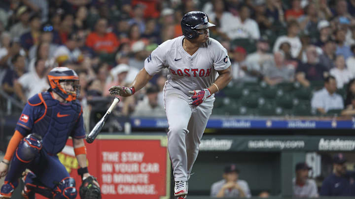 Aug 19, 2024; Houston, Texas, USA; Boston Red Sox third baseman Rafael Devers (11) hits a single during the first inning against the Houston Astros at Minute Maid Park. Mandatory Credit: Troy Taormina-Imagn Images