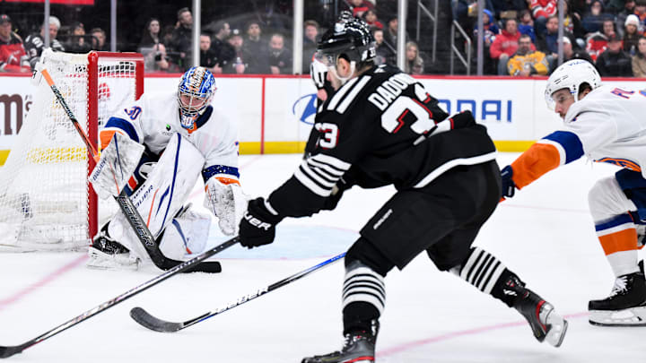Feb 5, 2026; Newark, New Jersey, USA; New York Islanders goaltender Ilya Sorokin (30) defends against New Jersey Devils left wing Evgenii Dadonov (33) during the second period at Prudential Center. Mandatory Credit: John Jones-Imagn Images