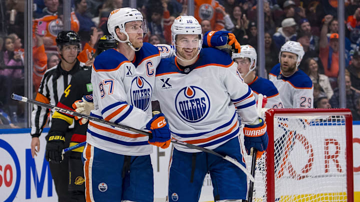 Edmonton Oilers forward Connor McDavid (97) celebrates with forward Zach Hyman (18) 
