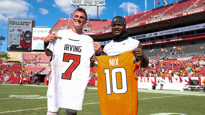 Sep 22, 2024; Tampa, Florida, USA; Tampa Bay Buccaneers running back Bucky Irving (7) and Denver Broncos quarterback Bo Nix (10) exchange jerseys after a game at Raymond James Stadium. Mandatory Credit: Nathan Ray Seebeck-Imagn Images