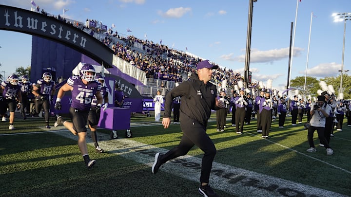 Sep 5, 2025; Evanston, Illinois, USA; Northwestern Wildcats head coach David Braun takes the field with his team against the Western Illinois Leathernecks at Northwestern Medicine Field at Martin Stadium. Mandatory Credit: David Banks-Imagn Images