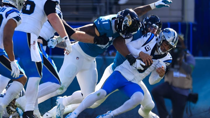 Carolina Panthers quarterback Bryce Young (9) is sacked by Jacksonville Jaguars linebacker Travon Walker (44) and as linebacker Josh Allen (41) looks on during the second quarter of a regular season NFL football matchup Sunday, Dec. 31, 2023 at EverBank Stadium in Jacksonville, Fla. The Jacksonville Jaguars blanked the Carolina Panthers 26-0. [Corey Perrine/Florida Times-Union]