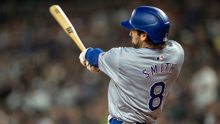 Sep 13, 2024; Seattle, Washington, USA;  Texas Rangers shortstop Josh Smith (8) hits a single during the first inning against the Seattle Mariners at T-Mobile Park