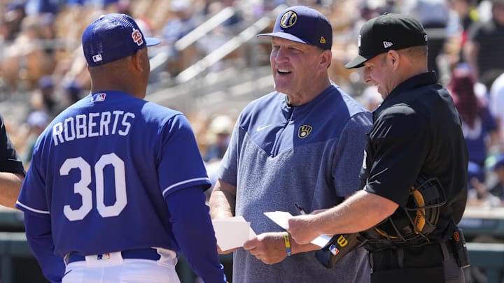 Mar 24, 2023; Phoenix, Arizona, USA; Los Angeles Dodgers manager Dave Roberts (30) and Milwaukee Brewers manager Pat Murphy (00) meet before a game at Camelback Ranch-Glendale. Mandatory Credit: Rick Scuteri-Imagn Images