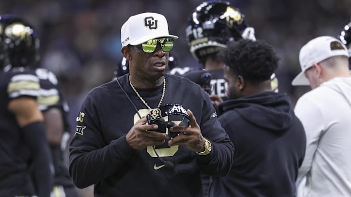 Dec 28, 2024; San Antonio, TX, USA; Colorado Buffaloes head coach Deion Sanders walks on the field between plays during the first quarter against the Brigham Young Cougars at Alamodome. Mandatory Credit: Troy Taormina-Imagn Images