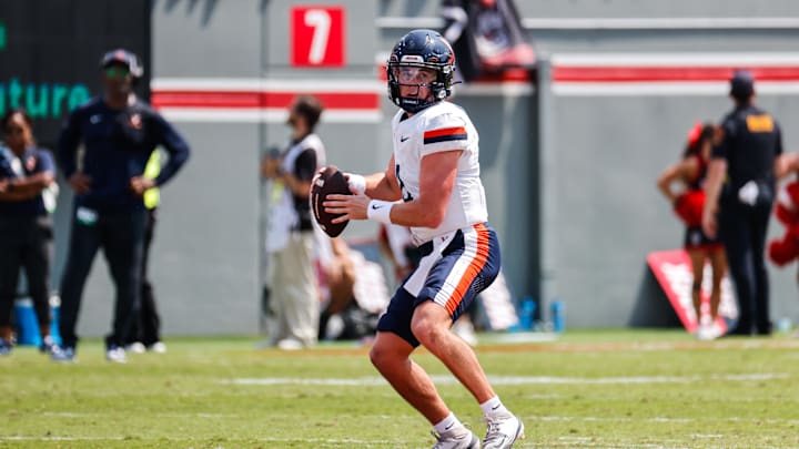 Sep 6, 2025; Raleigh, North Carolina, USA; Virginia Cavaliers quarterback Chandler Morris (4) runs with the football during the first half of the game against North Carolina State Wolfpack at Carter-Finley Stadium. Mandatory Credit: Jaylynn Nash-Imagn Images Sep 6, 2025; Raleigh, North Carolina, USA; Virginia Cavaliers quarterback Chandler Morris (4) runs with the football during the first half of the game against North Carolina State Wolfpack at Carter-Finley Stadium. Mandatory Credit: Jaylynn Nash-Imagn Images