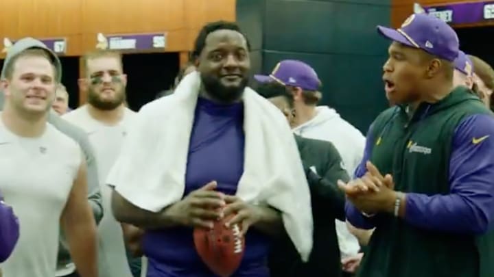Vikings left tackle Cam Robinson gets a game ball in the locker room after the win over the Colts.