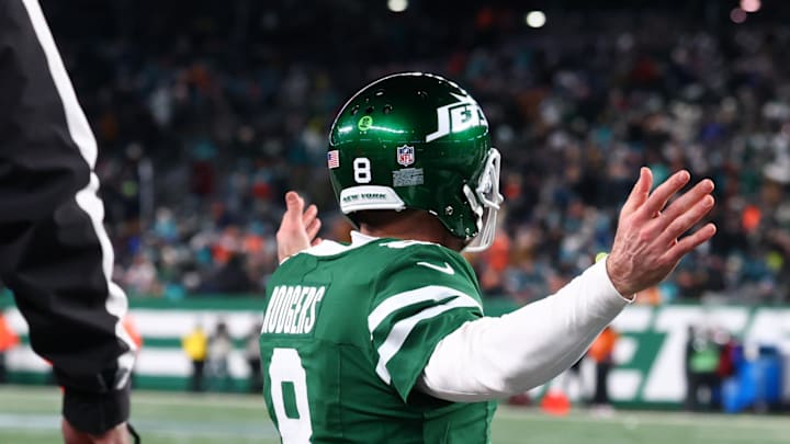 Jan 5, 2025; East Rutherford, New Jersey, USA; New York Jets quarterback Aaron Rodgers (8) celebrates his touchdown pass to New York Jets wide receiver Davante Adams (17) (not pictured) during the fourth quarter of their game against the Miami Dolphins at MetLife Stadium. Mandatory Credit: Ed Mulholland-Imagn Images