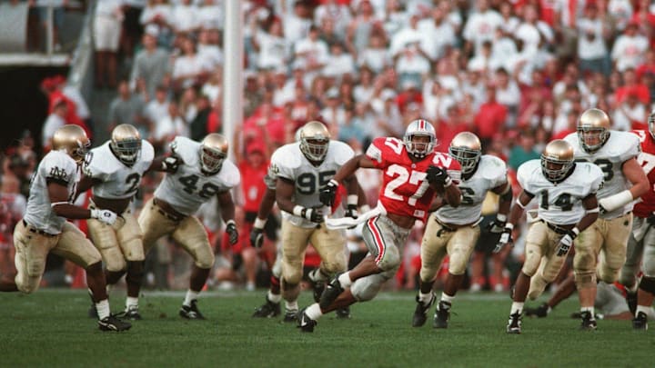 *** THIS IS THE FULL CROP of Fred Squillante's famous 1995 photo of Eddie George vs. Notre Dame. *** (Scanned in 10/97 for use in calendar of OSU's great football moments.) *** KEEP IN THE ARCHIVE ALONG WITH THE TIGHTER-CROPPED ONE! *** Eddie George gets away from the Notre Dame defense on a long run. OSU Buckeyes vs. Notre Dame Fighting Irish . Ohio State University college football . Game played on Sat., September 30, 1995 .