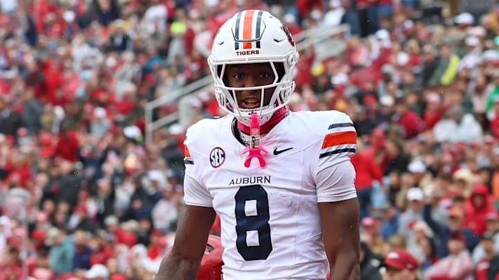 Auburn Tigers wide receiver Cam Coleman celebrates after scoring a touchdown defended by Arkansas Razorbacks defensive back Julian Neal during the first quarter at Donald W. Reynolds Razorback Stadium. 