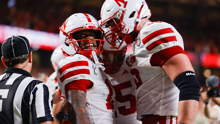 Wide receiver Nyziah Hunter (left) celebrates with teammates after his touchdown reception late in the first half against Cincinnati. 