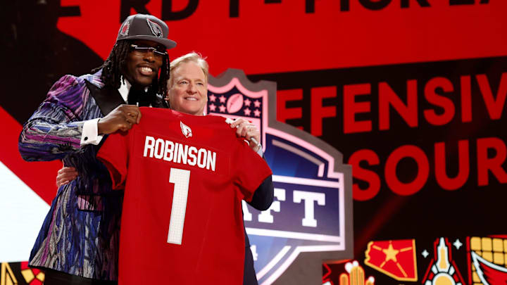 Missouri defensive lineman Darius Robinson greets NFL commissioner Roger Goodell and shows off his Arizona Cardinals jersey after he was picked in the first round of the 2024 NFL draft at the NFL draft theater in Detroit on Thursday, April 25, 2024.