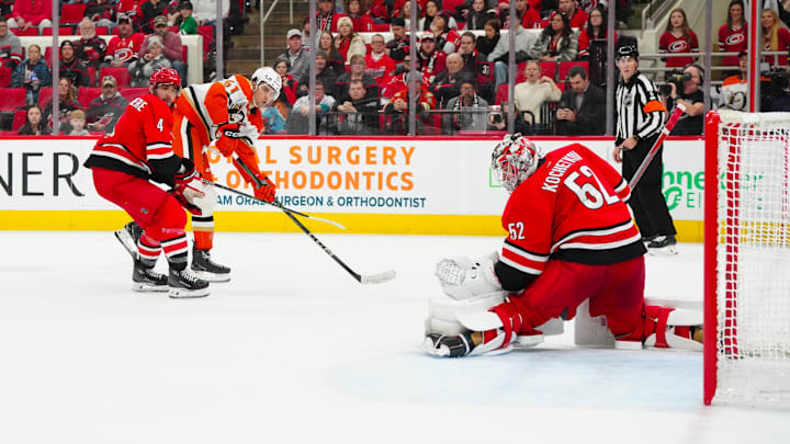 Jan 12, 2025; Raleigh, North Carolina, USA;  Anaheim Ducks left wing Cutter Gauthier (61) scores the game-winning goal in the over time past Carolina Hurricanes goaltender Pyotr Kochetkov (52) and defenseman Shayne Gostisbehere (4) at Lenovo Center. Mandatory Credit: James Guillory-Imagn Images