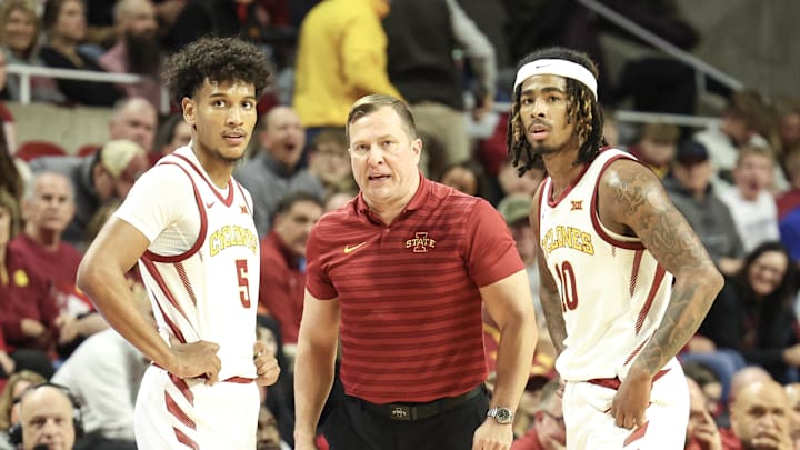 Jan 21, 2025; Ames, Iowa, USA; Iowa State Cyclones head coach T.J. Otzelberger talks with Iowa State Cyclones guard Curtis Jones (5) and Iowa State Cyclones guard Keshon Gilbert (10) during the second half of their game with the UCF Knights at James H. Hilton Coliseum. Mandatory Credit: Reese Strickland-Imagn Images