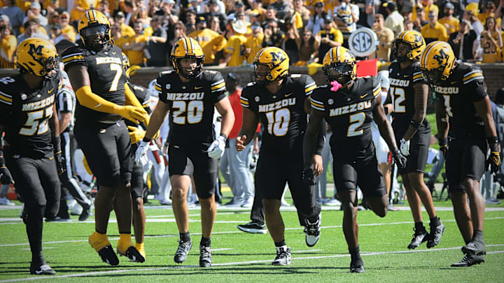 Oct 19, 2024; Columbia, Missouri, USA; The Missouri Tigers' defense runs off the field in celebration after recovering a turnover against the Auburn Tigers at Faurot Field at Memorial Stadium. Oct 19, 2024; Columbia, Missouri, USA; The Missouri Tigers' defense runs off the field in celebration after recovering a turnover against the Auburn Tigers at Faurot Field at Memorial Stadium.