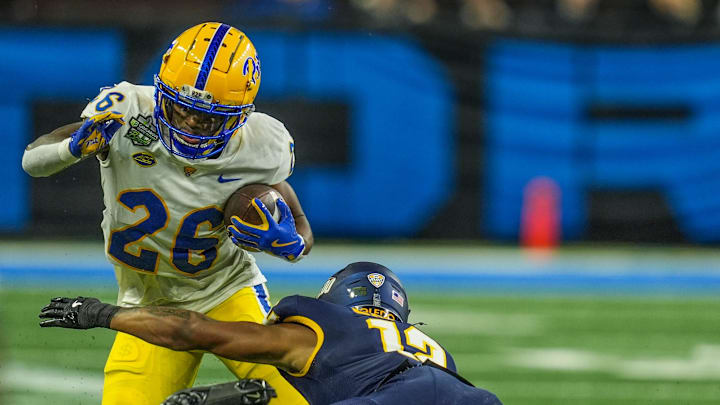 DUPLICATE***Pittsburgh Panthers running back Juelz Goff (26) runs for yards before being tackled by Toledo Rockets cornerback Avery Smith (12) during the first half of the 2024 GameAbove Sports Bowl at Ford Field in Detroit, Thursday, Dec. 26, 2024.