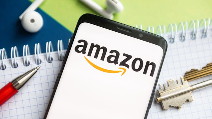In this photo illustration, an Amazon logo seen displayed on...
