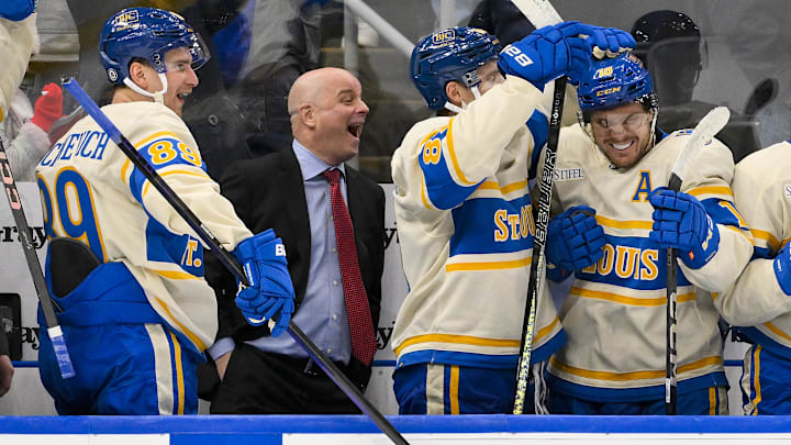 Feb 8, 2025; St. Louis, Missouri, USA;  St. Louis Blues left wing Pavel Buchnevich (89) head coach Jim Montgomery center Dylan Holloway (81) and center Robert Thomas (18) react after center Radek Faksa (not pictured) scored the game winning goal in the 10th round of shootouts against the Chicago Blackhawks at Enterprise Center. Mandatory Credit: Jeff Curry-Imagn Images