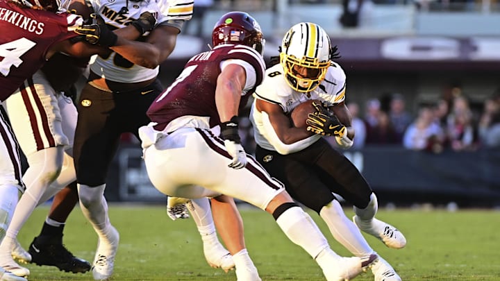 Nov 23, 2024; Starkville, Mississippi, USA; Missouri Tigers running back Nate Noel (8) runs against Mississippi State Bulldogs linebacker Stone Blanton (7) during the second quarter at Davis Wade Stadium at Scott Field. Mandatory Credit: Matt Bush-Imagn Images